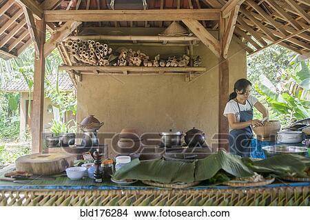 Picture - Asian chef cooking in outdoor kitchen. Fotosearch
