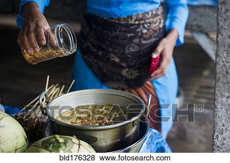 Stock Photo - Asian chef cooking in outdoor kitchen. Fotosearch