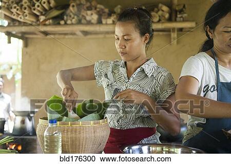 Stock Image - Asian chefs cooking in outdoor kitchen. Fotosearch