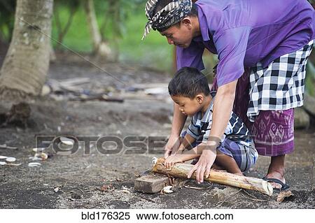 Asian father teaching son traditional wood carving View Large Photo Image Stock Photography - Asian father teaching son traditional wood carving. Fotosearch
