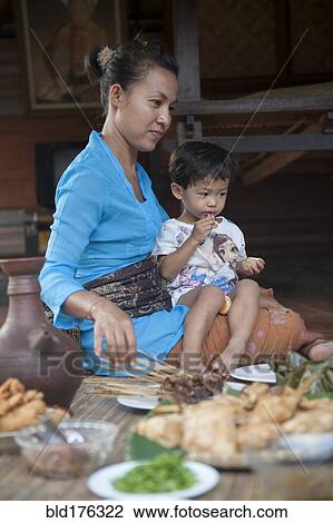 Asian mother and son eating on woven mat View Large Photo Image Stock Image - Asian mother and son eating on woven mat. Fotosearch