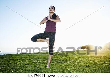 Asian woman practicing yoga outdoors View Large Photo Image Stock Image - Asian woman practicing yoga outdoors. Fotosearch