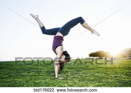 Asian woman practicing yoga outdoors View Large Photo Image Stock Image - Asian woman practicing yoga outdoors. Fotosearch