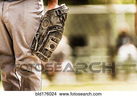 Baseball player wearing baseball glove View Large Photo Image Picture - Baseball player wearing baseball glove. Fotosearch