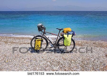 Bicycle parked on rocky beach View Large Photo Image Stock Image - Bicycle parked on rocky beach. Fotosearch
