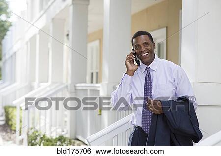 Stock Photograph - Black businessman talking on cell phone. Fotosearch