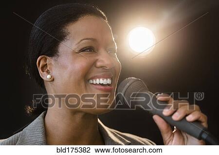 Black businesswoman talking into microphone View Large Photo Image Stock Image - Black businesswoman talking into microphone. Fotosearch