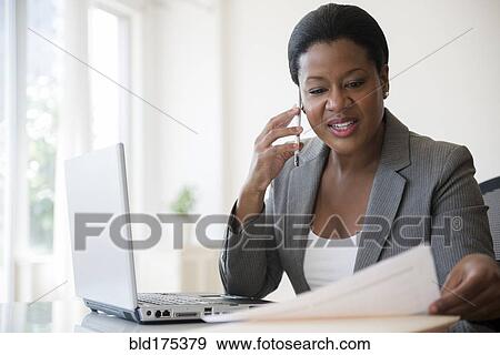 Black businesswoman talking on cell phone View Large Photo Image Stock Photo - Black businesswoman talking on cell phone. Fotosearch