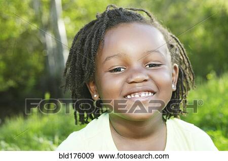 Black girl smiling outdoors View Large Photo Image Stock Photo - Black girl smiling outdoors. Fotosearch