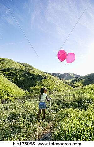 Black girl with balloons on rural hillside View Large Photo Image Stock Photography - Black girl with balloons on rural hillside. Fotosearch