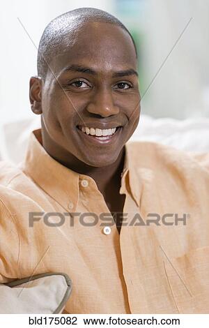 Black man smiling indoors View Large Photo Image Stock Image - Black man smiling indoors. Fotosearch