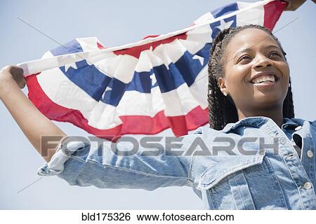 Black woman carrying American flag banner View Large Photo Image Stock Photograph - Black woman carrying American flag banner. Fotosearch