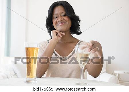 Black woman choosing between white wine and beer View Large Photo Image Stock Photography - Black woman choosing between white wine and beer. Fotosearch