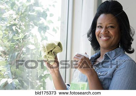 Black woman cleaning window View Large Photo Image Stock Image - Black woman cleaning window. Fotosearch