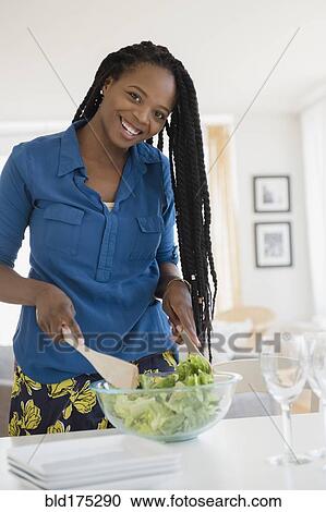 Stock Image - Black woman tossing salad. Fotosearch