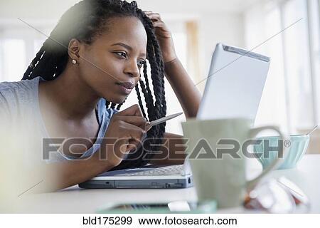 Stock Photo - Black woman using laptop. Fotosearch
