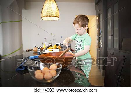 Boy cooking in kitchen View Large Photo Image Stock Image - Boy cooking in kitchen. Fotosearch