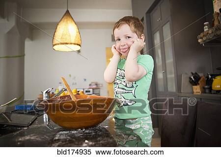 Stock Photography - Boy cooking in kitchen. Fotosearch