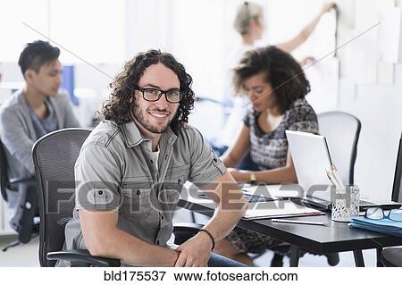 Stock Photo - Businessman smiling in meeting. Fotosearch