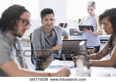 Businessman smiling in meeting View Large Photo Image Stock Photo - Businessman smiling in meeting. Fotosearch