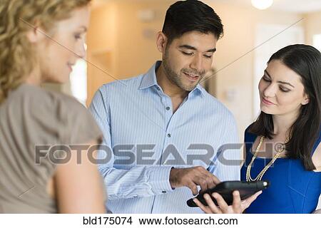 Picture - Businesspeople using digital tablet. Fotosearch