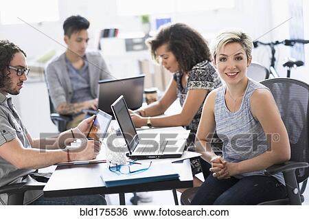 Stock Photograph - Businesswoman smiling in meeting. Fotosearch