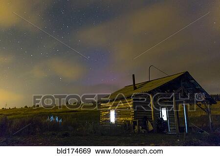 Stock Photo - Cabin in rural field at night. Fotosearch