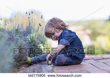 Stock Photography - Caucasian boy playing outdoors. Fotosearch