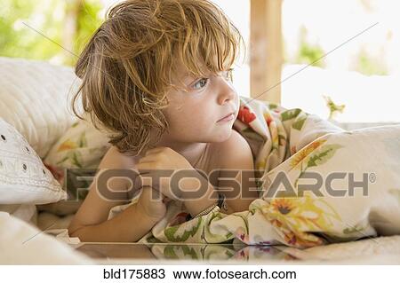 Stock Image - Caucasian boy playing with digital tablet. Fotosearch