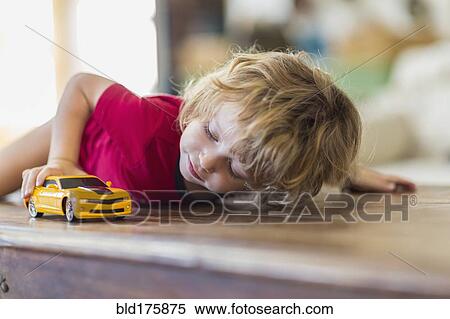 child playing with toy car