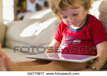 Caucasian boy using digital tablet View Large Photo Image Stock Photo - Caucasian boy using digital tablet. Fotosearch