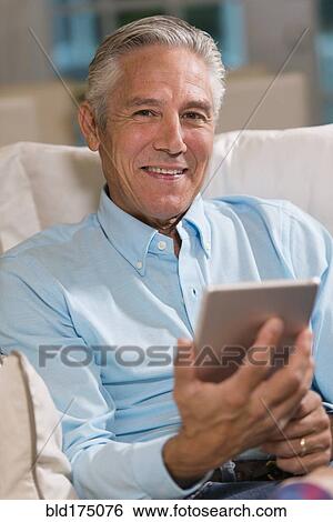 Caucasian businessman using digital tablet View Large Photo Image Stock Photograph - Caucasian businessman using digital tablet. Fotosearch