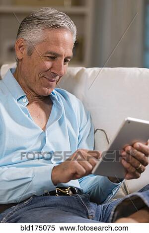 Stock Photography - Caucasian businessman using digital table. Fotosearch