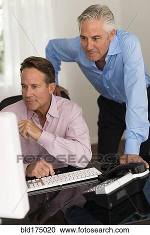 Caucasian businessmen working at computer View Large Photo Image Stock Image - Caucasian businessmen working at computer. Fotosearch
