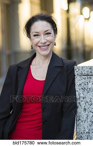 Stock Image - Caucasian businesswoman smiling outdoors. Fotosearch