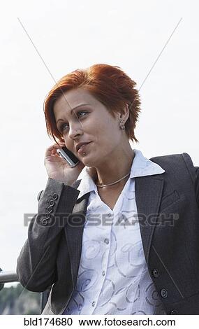Stock Image - Caucasian businesswoman talking on cell phone. Fotosearch