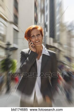 Caucasian businesswoman talking on cell phone in city View Large Photo Image Stock Photography - Caucasian businesswoman talking on cell phone in city. Fotosearch