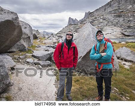 Caucasian climbers admiring mountainside View Large Photo Image Stock Photo - Caucasian climbers admiring mountainside. Fotosearch