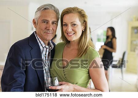 Stock Photo - Caucasian couple drinking wine at party. Fotosearch