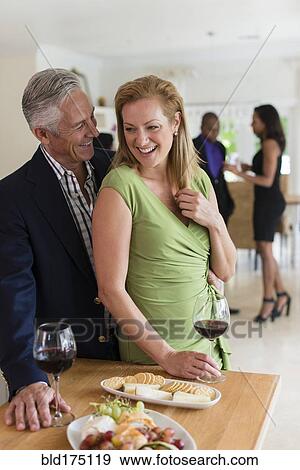 Caucasian couple drinking wine at party View Large Photo Image Stock Photo - Caucasian couple drinking wine at party. Fotosearch