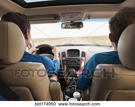 Stock Image - Caucasian couple driving in car. Fotosearch