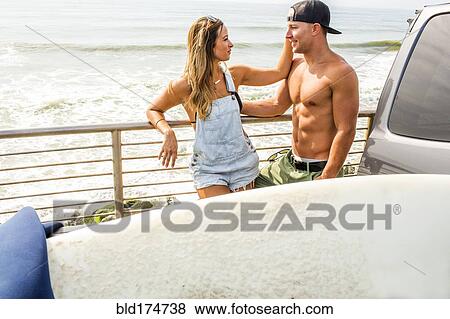 Stock Photo - Caucasian couple talking at beach. Fotosearch