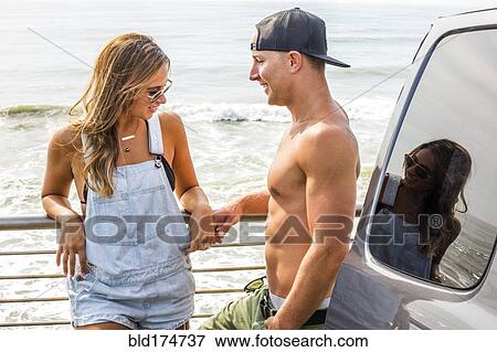 Stock Photo - Caucasian couple talking outdoors at beach. Fotosearch