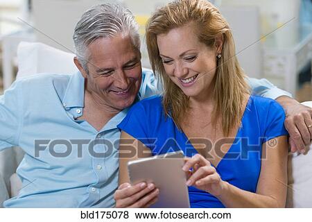 Stock Photo - Caucasian couple using digital tablet. Fotosearch