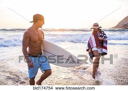 Caucasian couple walking on beach View Large Photo Image Picture - Caucasian couple walking on beach. Fotosearch