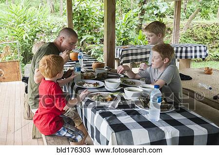 Caucasian family eating at picnic table outdoors View Large Photo Image Stock Image - Caucasian family eating at picnic table outdoors. Fotosearch