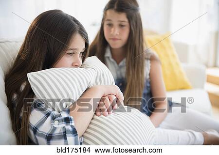 Picture - Caucasian girl comforting twin sister. Fotosearch