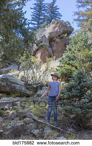 Stock Image - Caucasian girl exploring hillside. Fotosearch