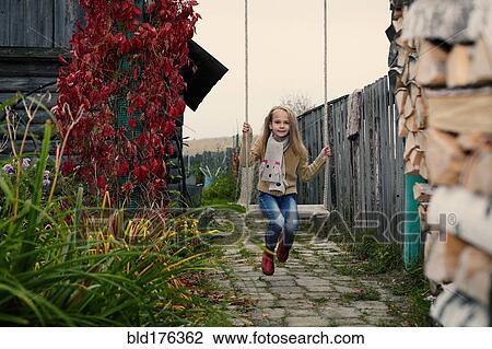 Caucasian girl playing on swing View Large Photo Image Stock Image - Caucasian girl playing on swing. Fotosearch