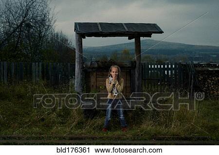 Caucasian girl waiting at rural train stop View Large Photo Image Stock Image - Caucasian girl waiting at rural train stop. Fotosearch